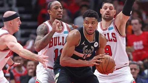 Giannis Antetokounmpo #34 of the Milwaukee Bucks looks to move against (L-R) Alex Caruso #6, DeMar DeRozan #11 and Nikola Vucevic #9 of the Chicago Bulls
