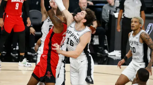 Cedi Osman #16 of the San Antonio Spurs blocks shot of Jabari Smith #10 of the Houston Rockets
