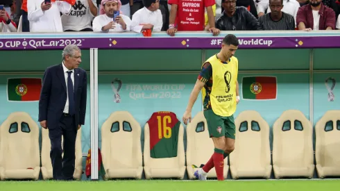 Cristiano Ronaldo reacts from the bench as Fernando Santos looks on during the FIFA World Cup Qatar 2022
