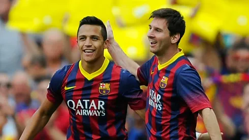 Alexis Sanchez celebrates with Lionel Messi at Barcelona.
