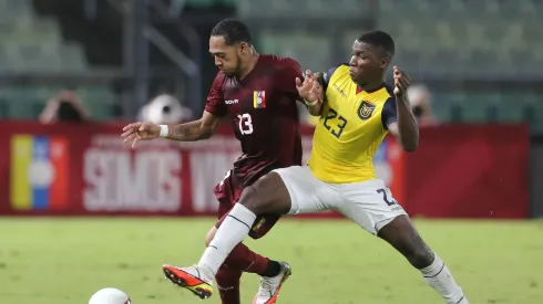 Jose Martinez of Venezuela and Moises Caicedo of Ecuador fight for the ball during a match in 2021.