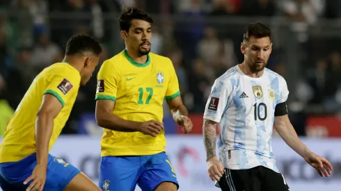 Lionel Messi competes for the ball with Lucas Paquetá (C) and Danilo da Silva (L) during a match in 2021.
