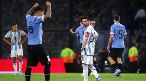 Lionel Messi of Argentina looks dejected as players of Uruguay celebrate.
