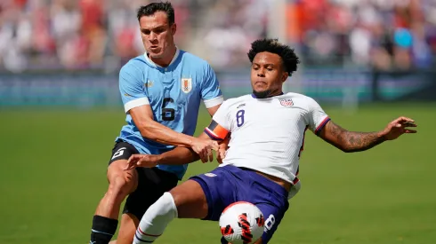 Manuel Ugarte #6 of Uruguay has the ball knocked away by Weston McKennie #8 of USA during the first half of the friendly matchat Children's Mercy Park on June 05, 2022 in Kansas City, Kansas. 
