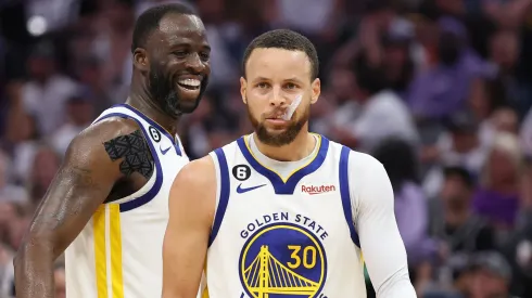 Stephen Curry and Draymond Green playing for the Golden State Warriors.
