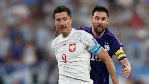 Robert Lewandowski under pressure from Lionel Messi during the FIFA World Cup Qatar 2022 Group C match between Poland and Argentina.
