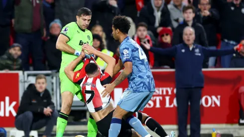 Emiliano Martinez and Boubacar Kamara of Aston Villa clash with Neal Maupay of Brentford during the Premier League match between Brentford FC and Aston Villa at Gtech Community Stadium on December 17, 2023 in Brentford, England.
