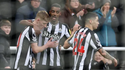 Alexander Isak of Newcastle United celebrates with teammates after scoring the team's first goal during the Premier League match between Newcastle United and Chelsea FC at St. James Park on November 25, 2023 in Newcastle upon Tyne, England.