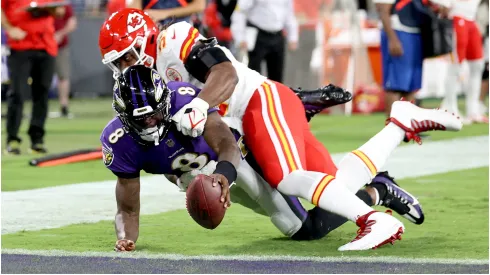 Lamar Jackson #8 of the Baltimore Ravens dives into the end zone for a touchdown past the tackle of Michael Danna #51 of the Kansas City Chiefs
