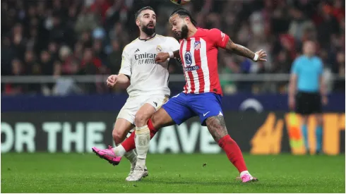 Memphis Depay of Atletico Madrid and Daniel Carvajal of Real Madrid