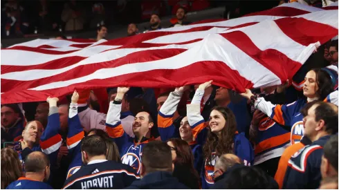 Fans wave the American flag

