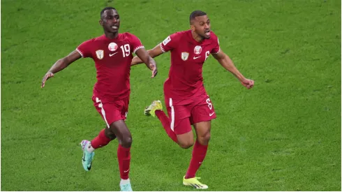 Almoez Ali of Qatar celebrates scoring their third goal with Abdulaziz Hatem
