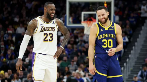 LeBron James and Stephen Curry laughing during a game.
