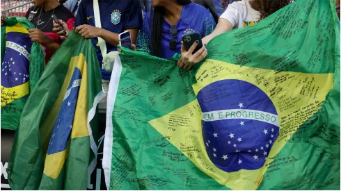 Fans hold Brazil flags
