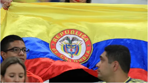 A fan of Colombia shows a Colombian flag