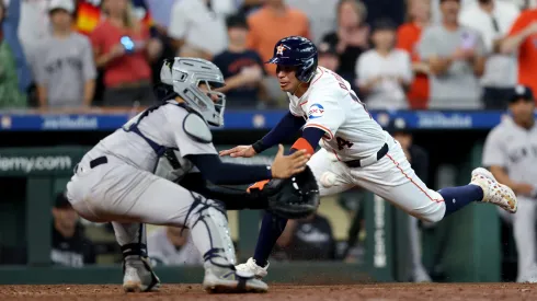 Mauricio Dubon #14 of the Houston Astros is out at the plate in the ninth inning against Jose Trevino #39 of the New York Yankees on Opening Day at Minute Maid Park on March 28, 2024 in Houston, Texas.

