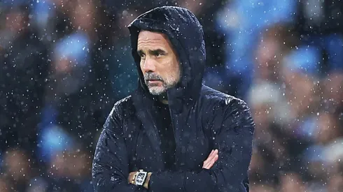 Man City coach Pep Guardiola looks on during a game.
