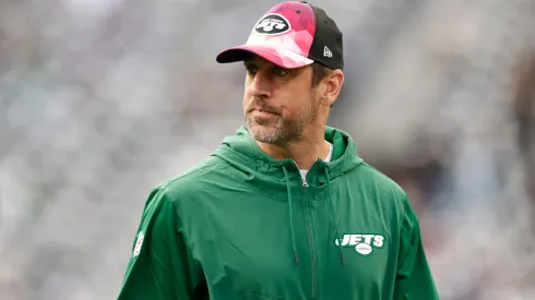 New York Jets star Aaron Rodgers watching a game from the sidelines.
