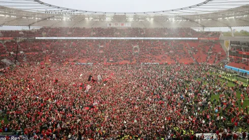 Fans of Bayer 04 Leverkusen invade the pitch after their team's victory and winning the Bundesliga title for the first time in their history
