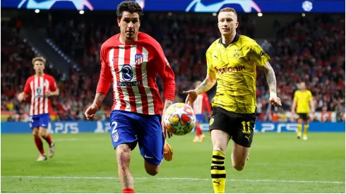 Jose Gimenez of Atletico de Madrid and Marco Reus of Borussia<br />
Dortmund

