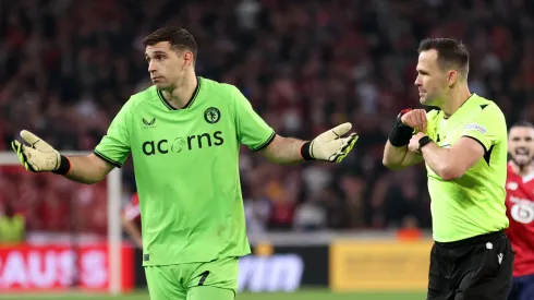 Emiliano Martinez of Aston Villa reacts after being shown a yellow card by Referee Ivan Kruzliak during the UEFA Europa Conference League 2023/24 Quarter-final second leg match between Lille OSC and Aston Villa at Stade Pierre-Mauroy on April 18, 2024 in Lille, France.
