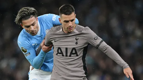 Jack Grealish of Manchester City battles for possession with Giovani Lo Celso of Tottenham Hotspur during the Premier League match between Manchester City and Tottenham Hotspur at Etihad Stadium on December 03, 2023 in Manchester, England.
