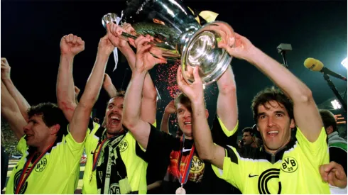 Andreas Möller, Jürgen Kohler, Martin Kree and Karlheinz Riedle hold up the Champions League trophy

