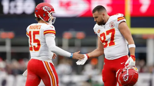 Patrick Mahomes #15 and Travis Kelce #87 of the Kansas City Chiefs high five during the first half against the New England Patriots at Gillette Stadium on December 17, 2023 in Foxborough, Massachusetts.
