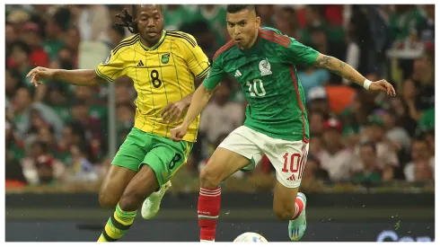 Daniel Johnson of Jamaica and Orbelin Pineda of Mexico fight for the ball during the match between Mexico and Jamaica