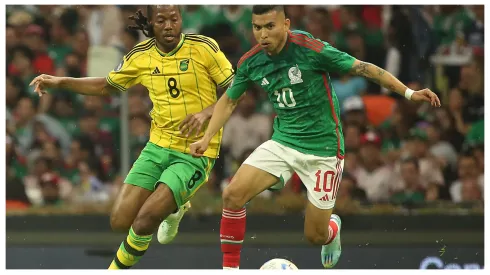 Daniel Johnson of Jamaica and Orbelin Pineda of Mexico fight for the ball during the match between Mexico and Jamaica

