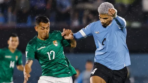 Roberto Fernandez (L) of Bolivia struggles for the ball against Ronald Araujo (R) of Uruguay during the FIFA World Cup 2026 Qualifier match between Uruguay and Bolivia at Centenario Stadium on November 21, 2023 in Montevideo, Uruguay.

