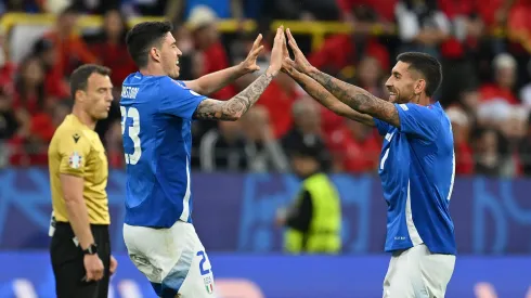 Alessandro Bastoni of Italy celebrates scoring his team's first goal with a header with teammate Lorenzo Pellegrini during the UEFA EURO 2024 group stage match between Italy and Albania.
