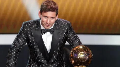Lionel Messi of Argentina receives the FIFA Ballon d'Or 2012 trophy.
