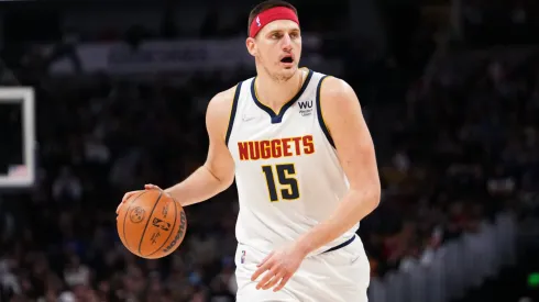 Nikola Jokic #15 of the Denver Nuggets dribbles against the Memphis Grizzlies at Ball Arena.
