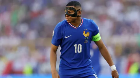 Kylian Mbappe of France looks on, whilst wearing a Black Protectice Face Mask after breaking his nose during the Group D fixture against Austria
