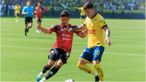 Cristian Calderon of Club America is defended by Jesus Garza of the Tigres UANL
