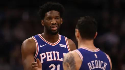 Joel Embiid #21 of the Philadelphia 76ers high fives JJ Redick #17 after scoring against the Phoenix Suns during the first half of the NBA game at Talking Stick Resort Arena on December 31, 2017 in Phoenix, Arizona.
