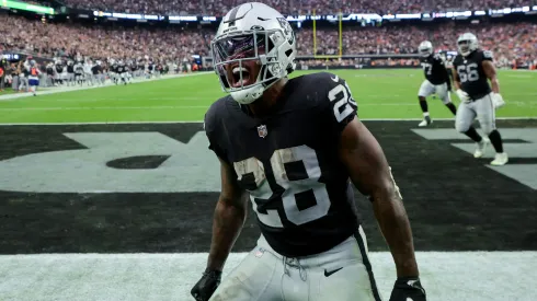Josh Jacobs #28 of the Las Vegas Raiders celebrates after scoring a touchdown in the fourth quarter against the Denver Broncos at Allegiant Stadium on October 02, 2022 in Las Vegas, Nevada. 
