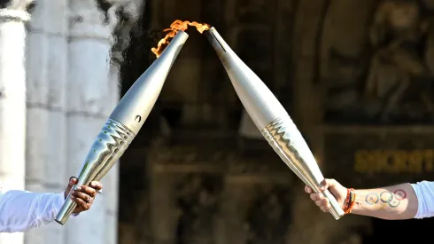 Claudia Tagbo, French-Ivorian actress and comedian and Pascal Touitou carry the Olympic Torch at Basilique du Sacre-Coeur de Montmartre during the second day of the Paris 2024 Olympic Torch Relay on July 15, 2024 in Paris, France.
