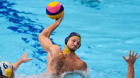 Alexey Shmider of Team Kazakhstan attacks under pressure from Lachlan Edwards (L) and Blake Edwards of Team Australia during the Men's Preliminary Round Group B match between Australia and Kazakhstan on day ten of the Tokyo 2020 Olympic Games.