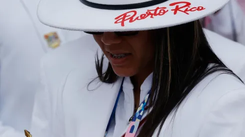 An athlete from Puerto Rico checks her smartphone as athletes from Puerto Rico's delegation prepare to board a boat to sail along the river Seine during the Opening Ceremony of the Olympic Games Paris 2024 on July 26, 2024 in Paris, France.