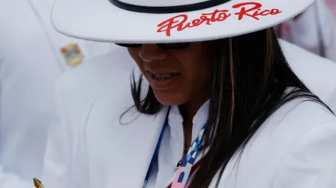 An athlete from Puerto Rico checks her smartphone as athletes from Puerto Rico's delegation prepare to board a boat to sail along the river Seine during the Opening Ceremony of the Olympic Games Paris 2024 on July 26, 2024 in Paris, France.
