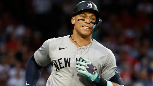 Aaron Judge #99 of the New York Yankees smiles as he watches his hit fall for an RBI single in right field during the first inning against the Boston Red Sox at Fenway Park on July 28, 2024 in Boston, Massachusetts.
