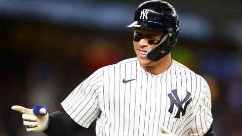 Aaron Judge #99 of the New York Yankees points to the dugout after hitting his third home run of the game against the Washington Nationals at Yankee Stadium on August 23, 2023 in the Bronx borough of New York City. 
