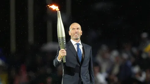 Zinedine Zidane holding the Olympics torchZinedine Zidane holding the Olympics torch
