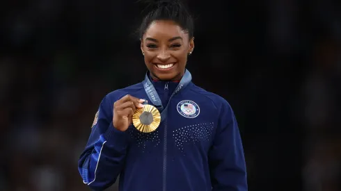 Gold medalist Simone Biles of Team United States celebrates on the podium during the medal ceremony for the Artistic Gymnastics Women's Vault Final on day eight of the Olympic Games Paris 2024 at Bercy Arena on August 03, 2024 in Paris, France.
