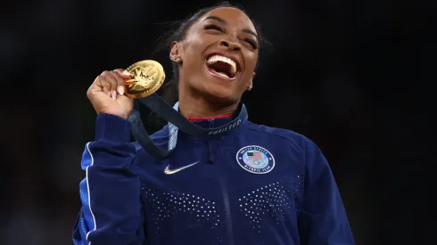 Gold medalist Simone Biles of Team United States celebrates on the podium during the medal ceremony for the Artistic Gymnastics Women's Vault Final on day eight of the Olympic Games Paris 2024 at Bercy Arena on August 03, 2024 in Paris, France.