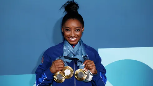 Simone Biles of Team United States poses with her Paris 2024 Olympic medals following the Artistic Gymnastics Women's Floor Exercise Final.
