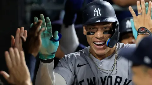 Aaron Judge #99 of the New York Yankees celebrates his three-run home run, his 300th career home run, with teammates in the dugout during the eighth inning against the Chicago White Sox at Guaranteed Rate Field on August 14, 2024 in Chicago, Illinois. 
