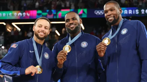 Stephen Curry, LeBron James, and Kevin Durant of Team United States pose for a photo during the Men's basketball medal ceremony on day fifteen of the Olympic Games Paris 2024 at Bercy Arena on August 10, 2024 in Paris, France.